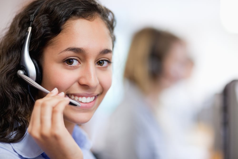 Close up of a smiling customer assistant wearing a headset