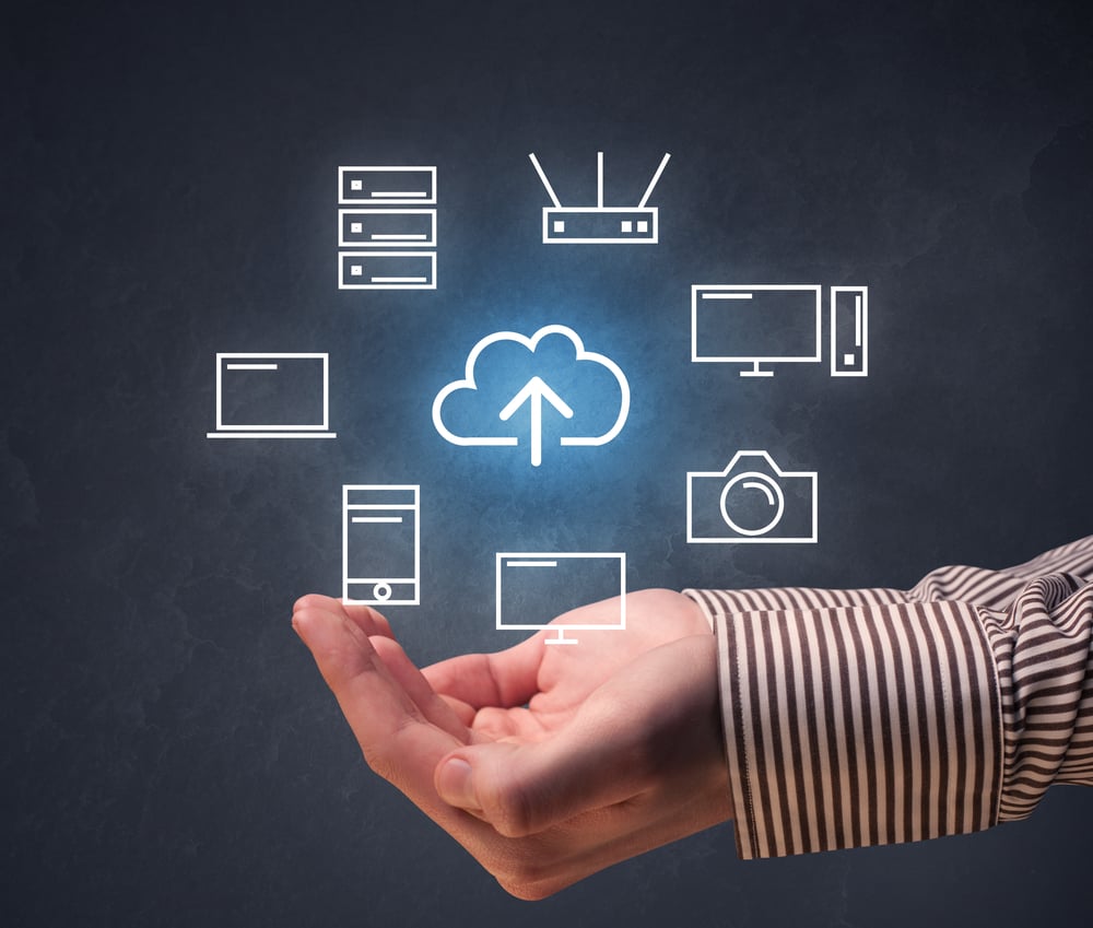 Cloud and computing related icons hovering over young hand
