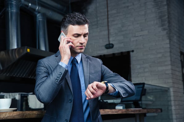 Guy looking at his watch in a call center