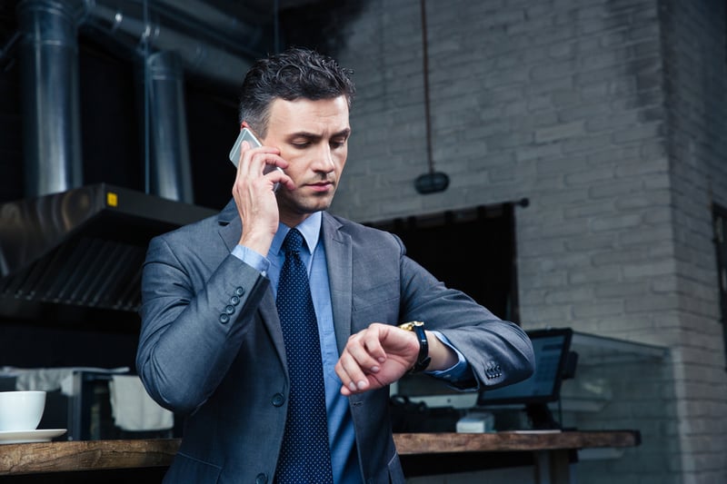 Guy looking at his watch in a call center