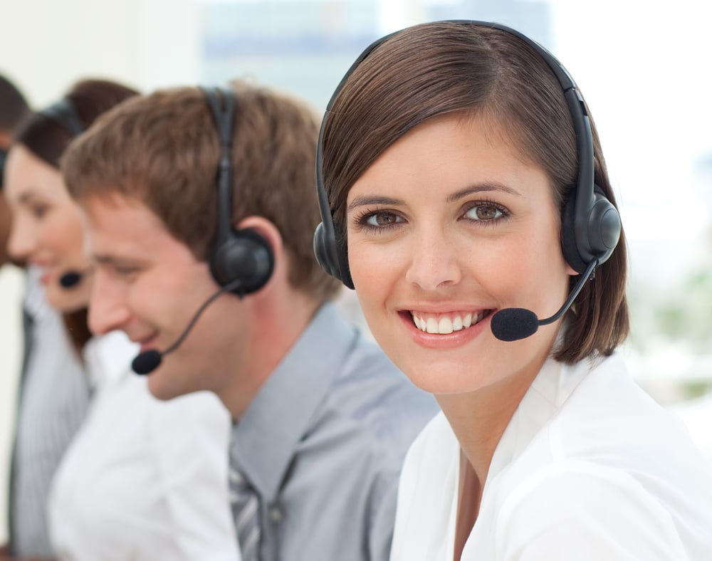 Female customer service agent with headset on in a call center