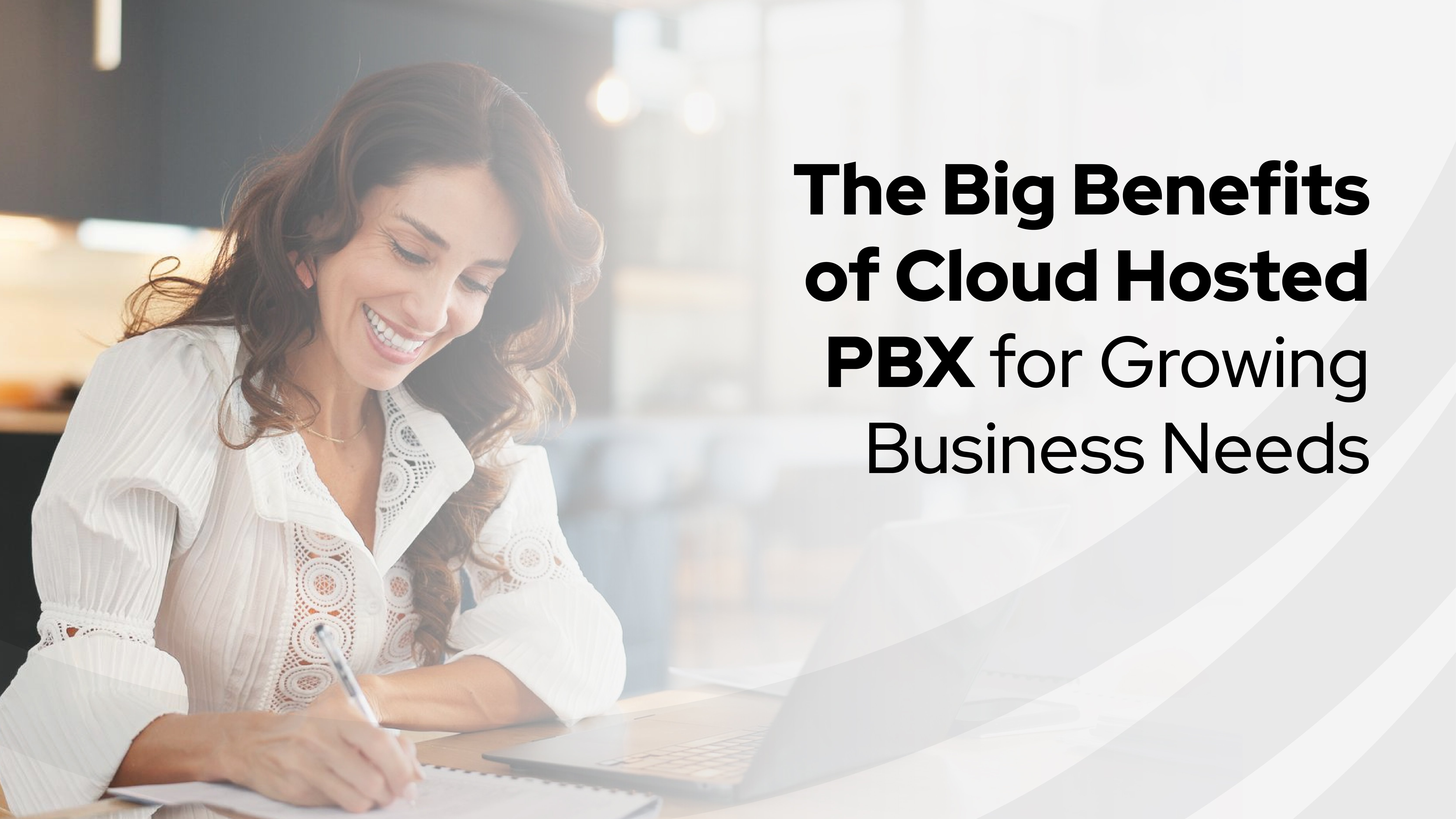 Smiling professional using a laptop while writing notes, highlighting the benefits of hosted pbx for growing businesses and cloud-based communication.