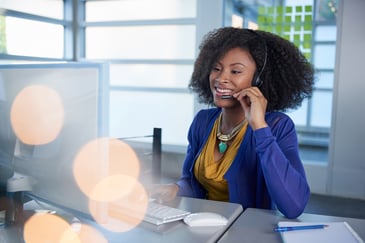 Customer service representative talking to a client on a headset