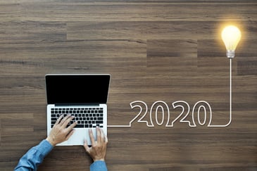 Stock image of a person's hands typing on a laptop, with